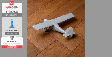 3D-printed model of an airplane on a wooden floor, showcasing its wings and tail design.
