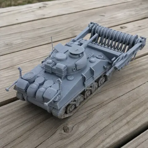 3D-printed Crab Sherman tank model with mine flail, detailed and placed on wooden surface.