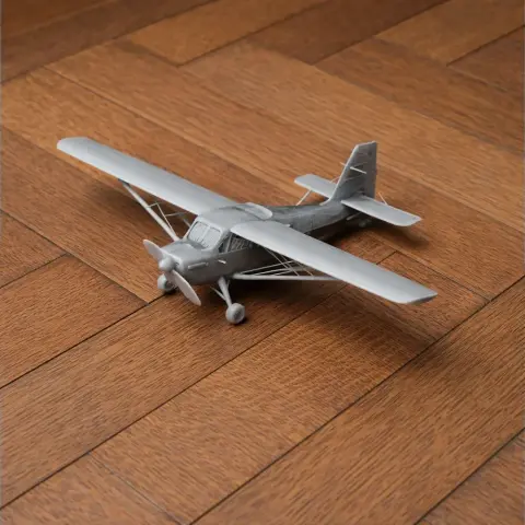 A detailed 3D-printed model of a small propeller aircraft on a wooden surface.