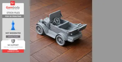 3D printed gray model of an antique car on a wooden surface.