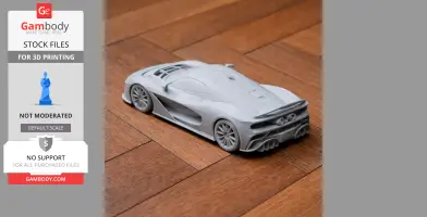 A detailed 3D-printed scale model of a sleek sports car on a wooden surface.