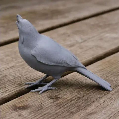 Grey 3D-printed bird model, standing with open beak on wooden surface.