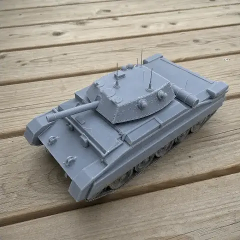 A detailed 3D-printed Crusader tank model on a wooden surface.