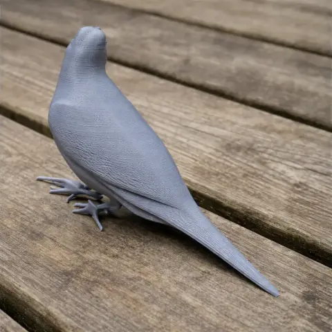 3D-printed bird model with detailed texture, perched on a wooden surface.