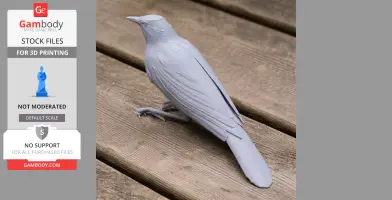 A detailed 3D printed model of a bird, resembling a starling, placed on a wooden surface.
