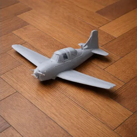 3D-printed scale model of a Beechcraft T-34 Mentor airplane on a wooden surface.