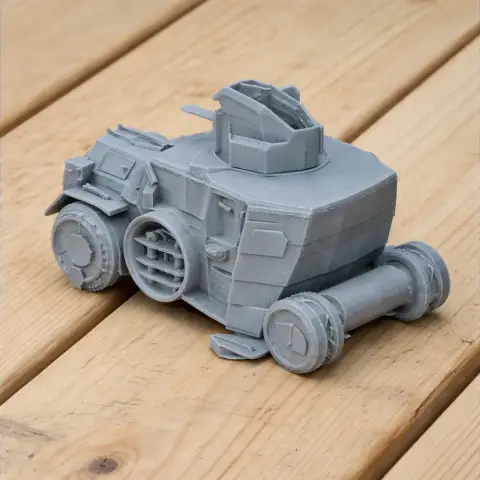 Gray 3D-printed model of a Daimler DZVR 21 tank on a wooden surface.