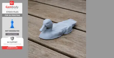 Gray 3D-printed model of a duck on wooden surface.