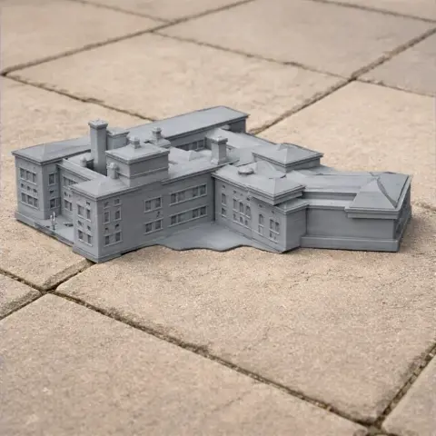 Gray 3D-printed model of a large, historic building on a tiled surface.