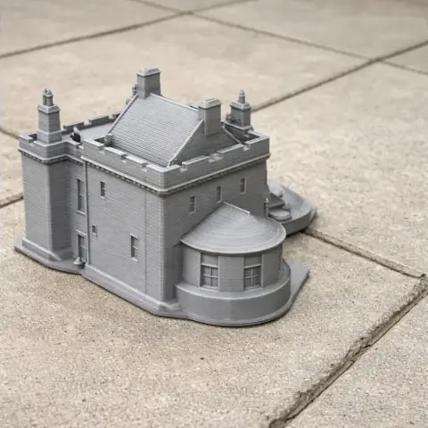 Miniature 3D-printed model of Brackenhill Tower, showcasing detailed architecture on a tiled surface.
