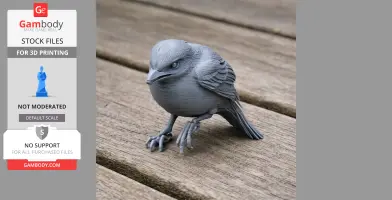 Gray 3D-printed Bahama mockingbird model with detailed feathers on a wooden surface.