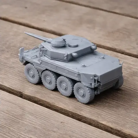 A detailed 3D-printed model of a multi-wheeled armored military vehicle on a wooden surface.
