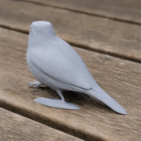A 3D-printed model of a bird standing on a wooden surface.
