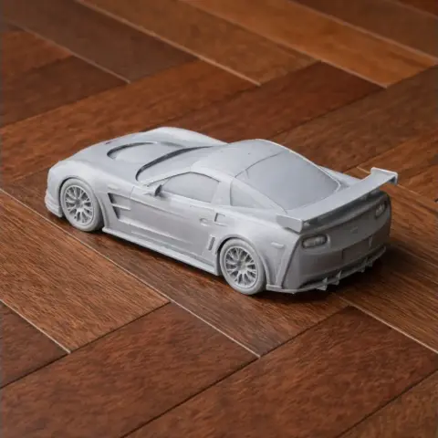 3D printed model of a Chevrolet Corvette C6 on a wooden floor.