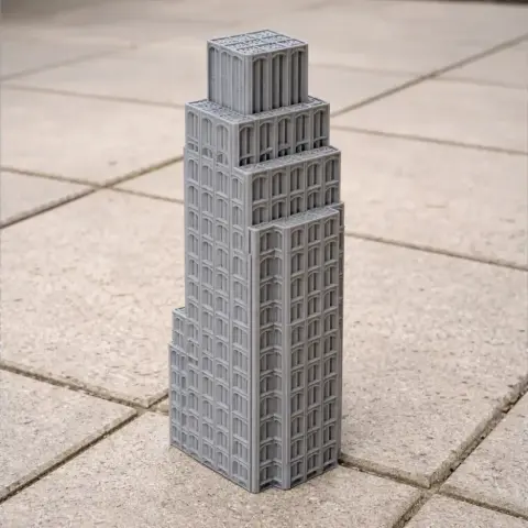 3D printed model of a tiered, modern skyscraper with rectangular windows on tiled surface.