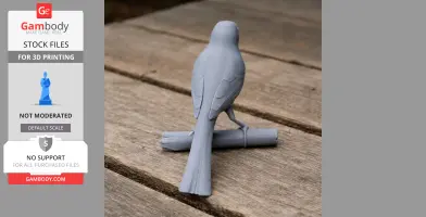 A 3D printed model of a bird perched on a branch, viewed from behind, on a wooden surface.