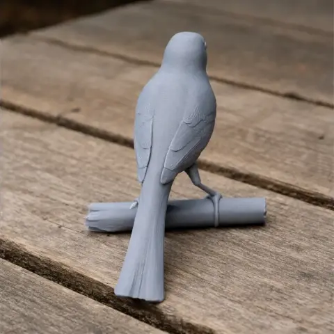 3D model of a small bird perched on a log, designed for 3D printing.