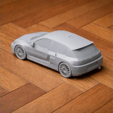 3D printed model of a Clio V6 Renault Sport car on a wooden floor.