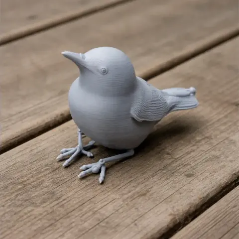 3D printed model of a bird with detailed feathers and beak, resting on a wooden surface.