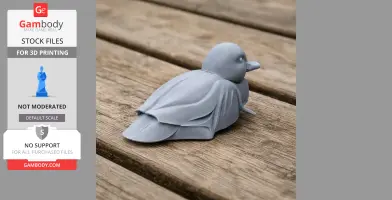 A gray 3D-printed model of a Baikal teal duck sitting on a wooden surface.