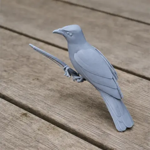 3D printed model of Baird's trogon bird perched on a branch, placed on a wooden surface.