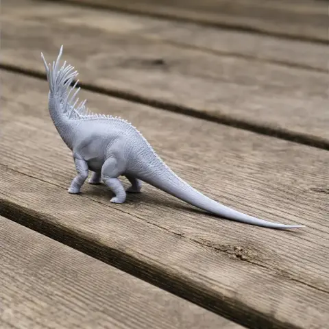 3D-printed Bajadasaurus model with spiky neck on a wooden surface.