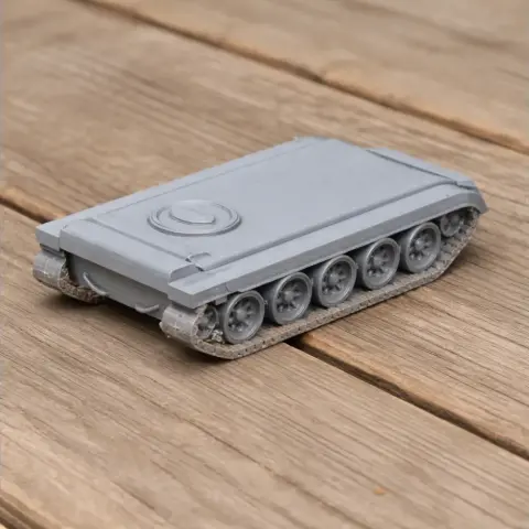 Gray 3D-printed tank model with detailed tracks on a wooden surface.