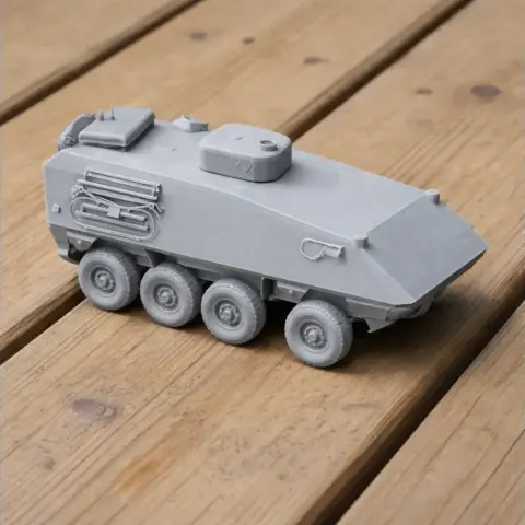3D-printed model of a KTO Rys tank with six wheels, showcased on a wooden surface.