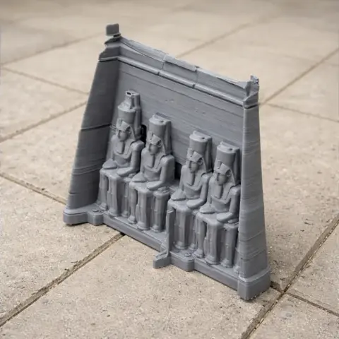 Miniature 3D print of Abu Simbel temple facade with seated pharaoh statues.