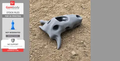 Gray 3D-printed Taniwhasaurus skull replica on a sandy surface.