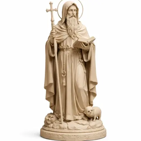 Saint Anthony the Great statue holding a cross and book, with animals at his feet.