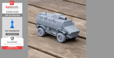 Gray 3D-printed model of an armored tactical vehicle on a wooden surface.