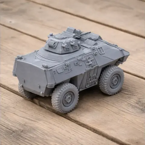 A detailed 3D-printed model of a GKN Simba tank on a wooden surface.