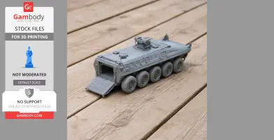 A 3D-printed model of an eight-wheeled Lazar armored vehicle with a rear ramp, displayed on wooden boards.