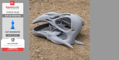 A detailed 3D-printed Tengrisaurus skull replica resting on sandy ground.