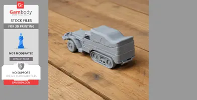 Gray 3D-printed model of an M3 half-track vehicle on a wooden surface.