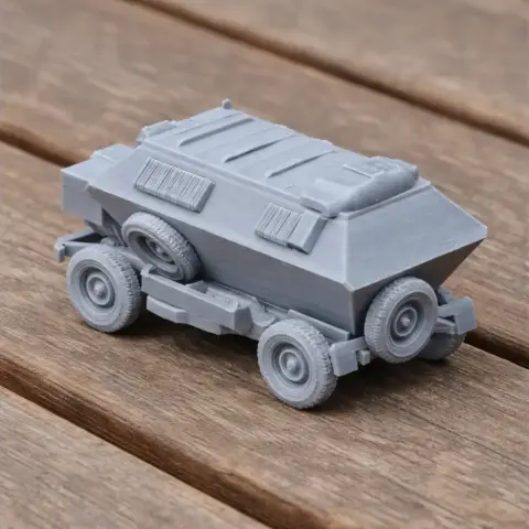 3D-printed MAP75 armored personnel carrier model on a wooden surface.