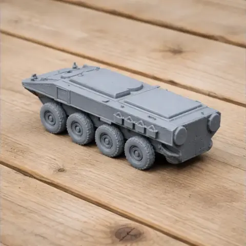 Gray 3D-printed model of an eight-wheeled Marine Personnel Carrier on a wooden surface.
