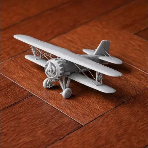3D printed Curtiss Gulfhawk biplane model on a wooden surface.