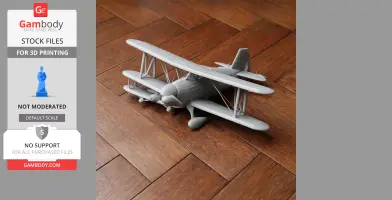 A detailed 3D printed model of a biplane on a wooden floor.
