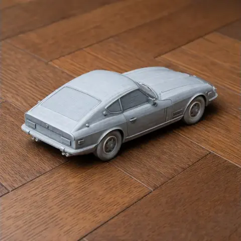 3D printed scale model of a classic Datsun Sports car on a wooden surface.