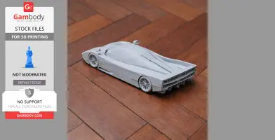 3D-printed model of a Dauer 962 Le Mans car on a wooden floor, viewed from the rear side.