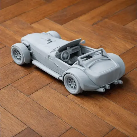 3D-printed model of a DAX Rush vehicle on a wooden floor.