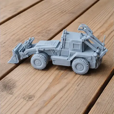 A detailed 3D-printed model of a military engineering vehicle on a wooden surface.