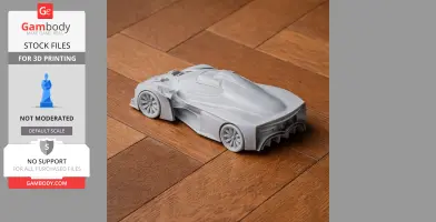 3D printed model of a sleek, futuristic car on a wooden surface.