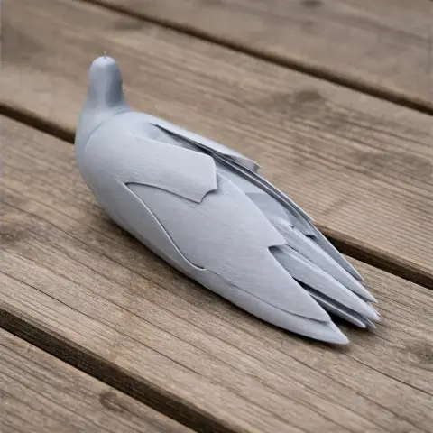 3D-printed model of a stylized bird with detailed feathers, resting on wooden planks.