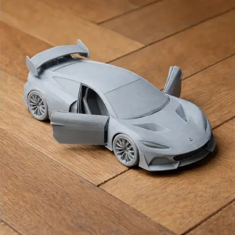 3D printed scale model of a sleek sports car with open scissor doors on a wooden surface.