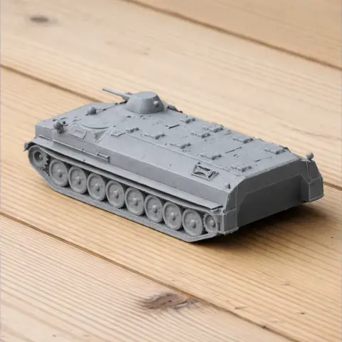 3D-printed gray tank model with detailed tracks and a flat top, displayed on a wooden surface.