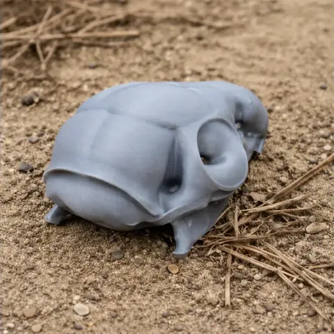3D-printed tree shrew skull replica resting on a sandy surface.