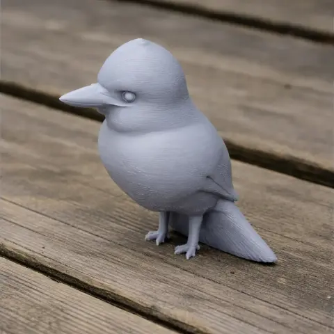 3D printed model of a banded kingfisher, with smooth details, perched on a wooden surface.